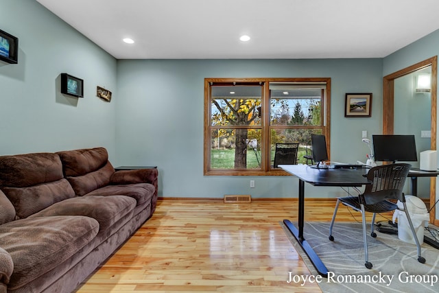 office with light hardwood / wood-style flooring