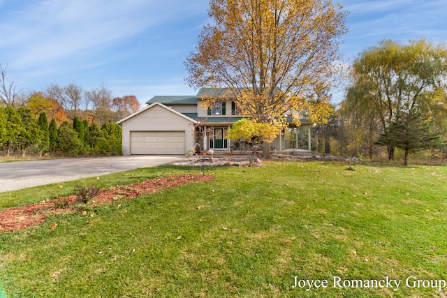 view of front of property featuring a front yard and a garage