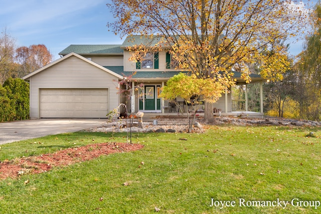 view of front of house featuring covered porch, a front yard, and a garage