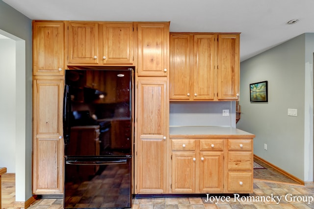 kitchen with black refrigerator