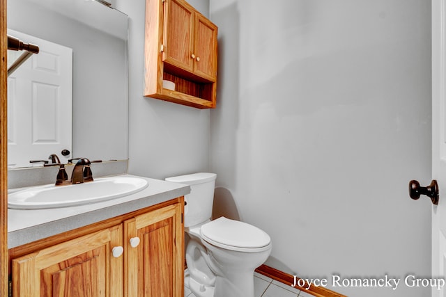 bathroom with vanity, toilet, and tile patterned flooring