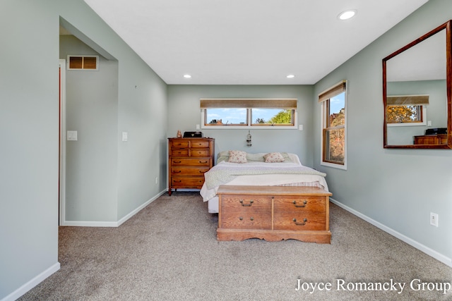 bedroom featuring light carpet