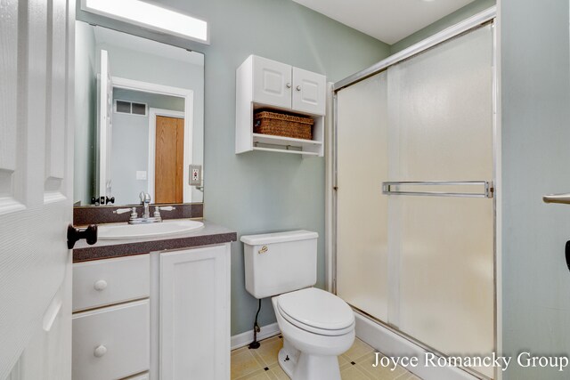 bathroom with vanity, toilet, and walk in shower