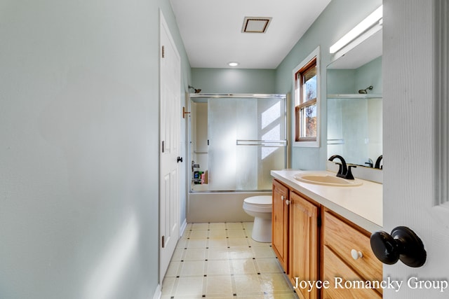 full bathroom featuring vanity, toilet, and enclosed tub / shower combo