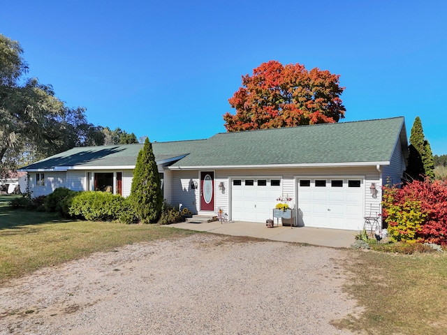 single story home featuring a front lawn and a garage