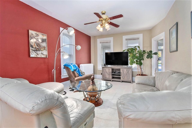 carpeted living room with ceiling fan and a healthy amount of sunlight