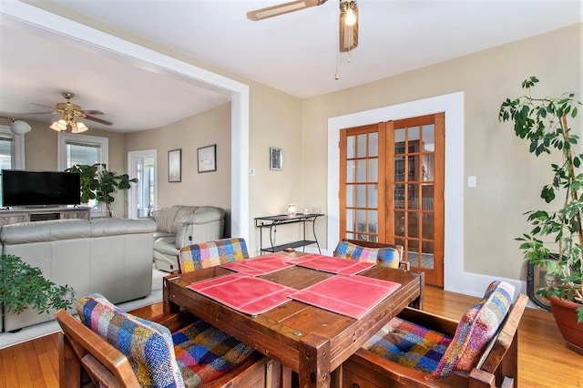 dining area with ceiling fan, french doors, and light hardwood / wood-style floors