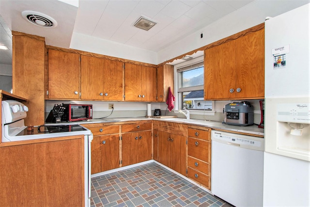 kitchen featuring sink and white appliances