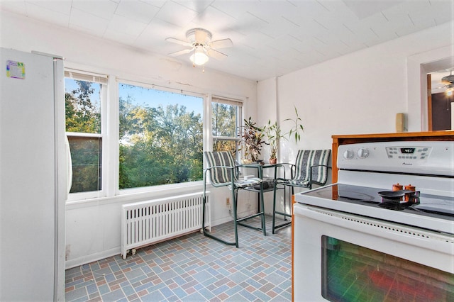 miscellaneous room featuring radiator heating unit and ceiling fan