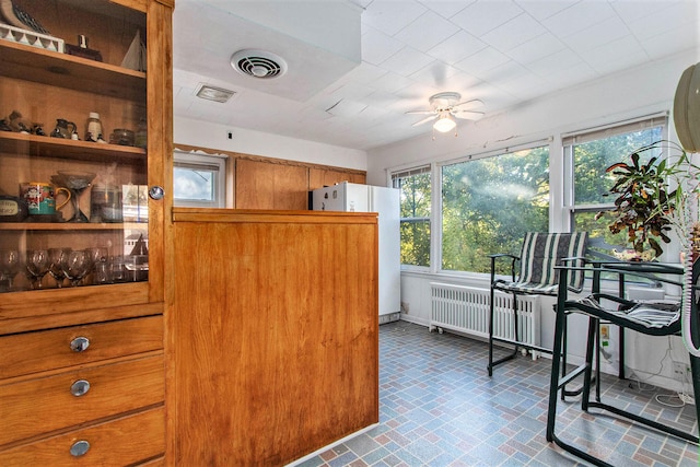 kitchen with radiator, ceiling fan, and white fridge