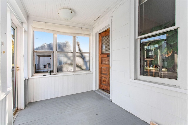 unfurnished sunroom with wooden ceiling