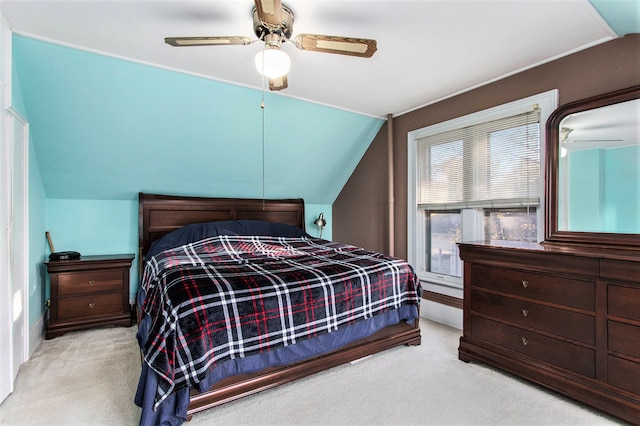 bedroom featuring ceiling fan, lofted ceiling, and light colored carpet