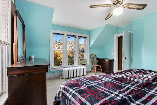 bedroom with radiator heating unit, light carpet, and ceiling fan