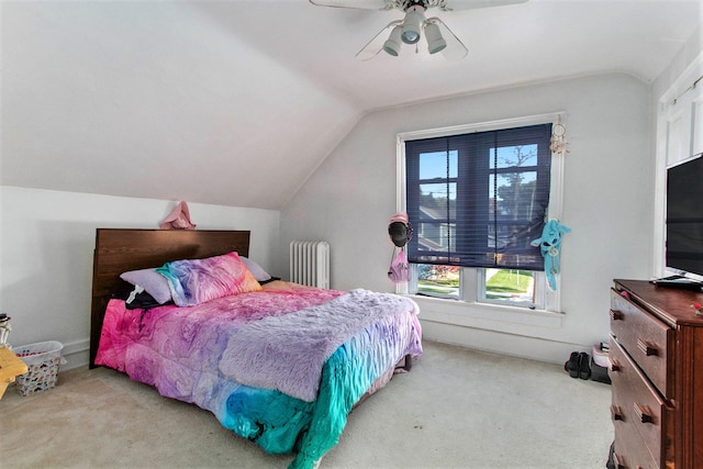 bedroom with light colored carpet, ceiling fan, vaulted ceiling, and radiator