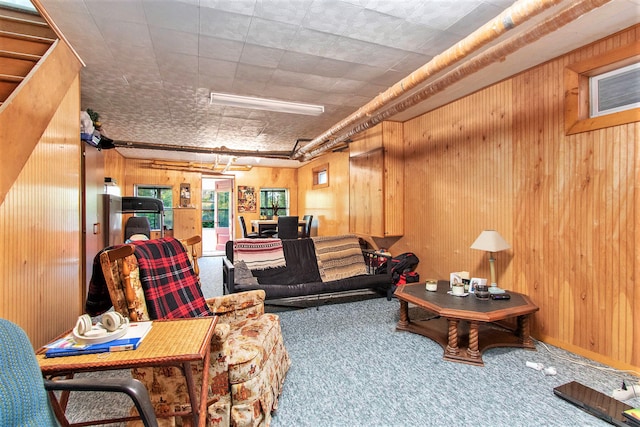 living room with wood walls and carpet