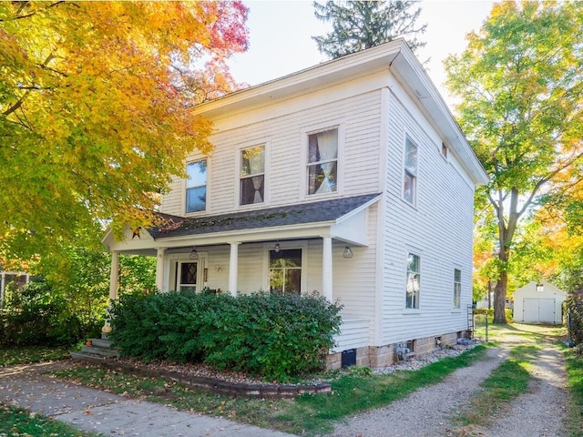 view of front facade featuring a shed and a porch