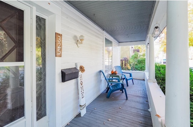 wooden terrace featuring covered porch