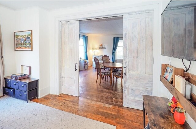 dining area featuring ornamental molding and dark hardwood / wood-style floors