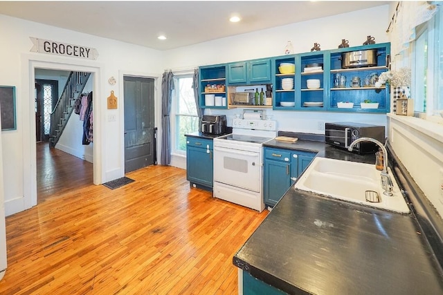 kitchen with light hardwood / wood-style floors, blue cabinets, sink, and electric stove