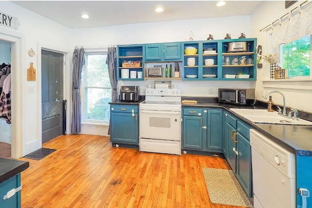 kitchen with white appliances, light hardwood / wood-style flooring, sink, and blue cabinets