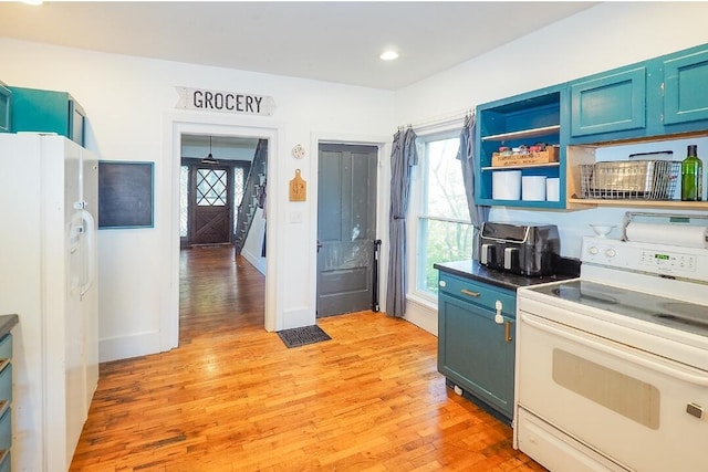 kitchen featuring light hardwood / wood-style floors, a healthy amount of sunlight, and white appliances