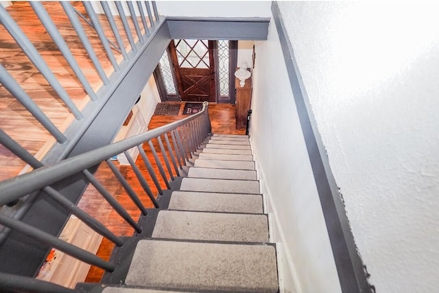 stairs featuring hardwood / wood-style flooring