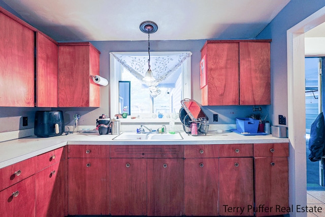 kitchen with sink, hanging light fixtures, and plenty of natural light