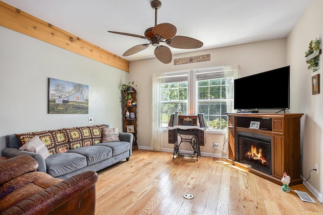 living room featuring light wood-type flooring and ceiling fan