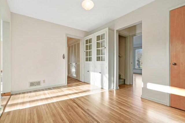 unfurnished room with light wood-type flooring