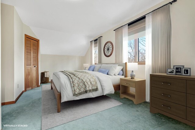 bedroom featuring a closet, light colored carpet, and vaulted ceiling