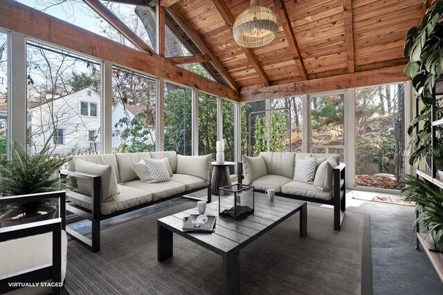 sunroom / solarium with a chandelier, vaulted ceiling with beams, and plenty of natural light