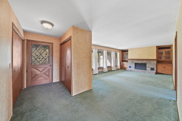 unfurnished living room featuring carpet and a fireplace