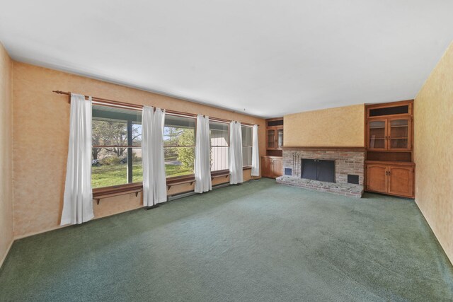 unfurnished living room featuring carpet flooring and a brick fireplace