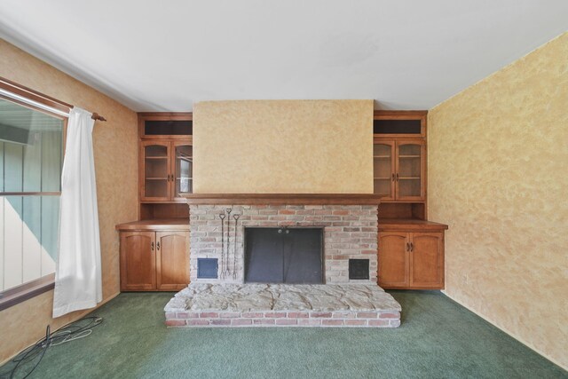 unfurnished living room featuring dark carpet and a fireplace