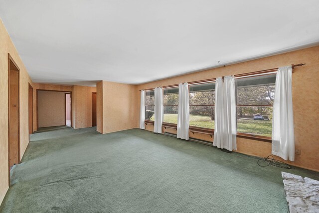 empty room with dark colored carpet