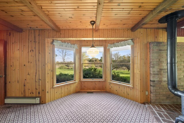 unfurnished sunroom featuring plenty of natural light, beam ceiling, and a baseboard radiator