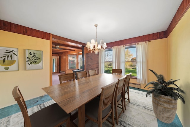 carpeted dining space with an inviting chandelier, a baseboard heating unit, and beamed ceiling