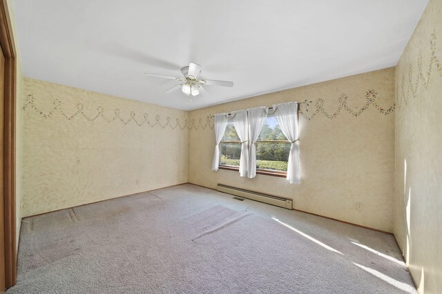 unfurnished room with ceiling fan, baseboard heating, and light colored carpet