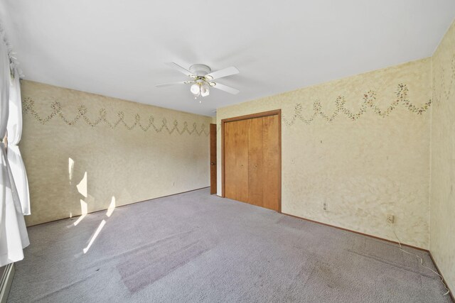 empty room with carpet floors and ceiling fan