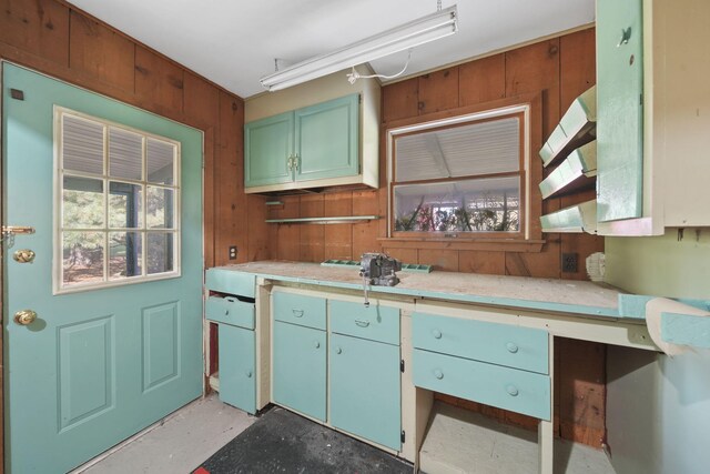 kitchen featuring wood walls and a wealth of natural light