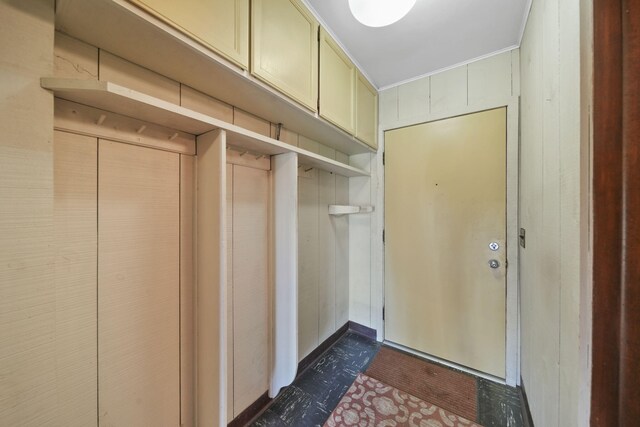 mudroom with wood walls