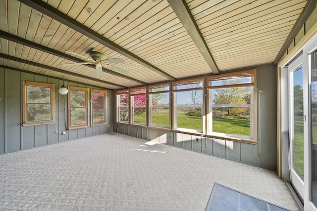 unfurnished sunroom with wood ceiling, lofted ceiling with beams, ceiling fan, and plenty of natural light