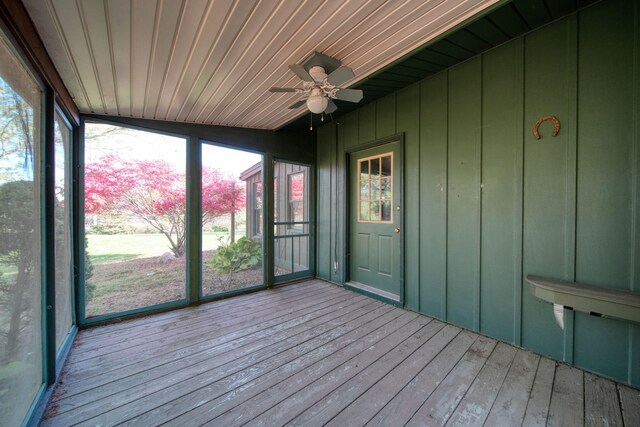 unfurnished sunroom featuring lofted ceiling, wood ceiling, and ceiling fan