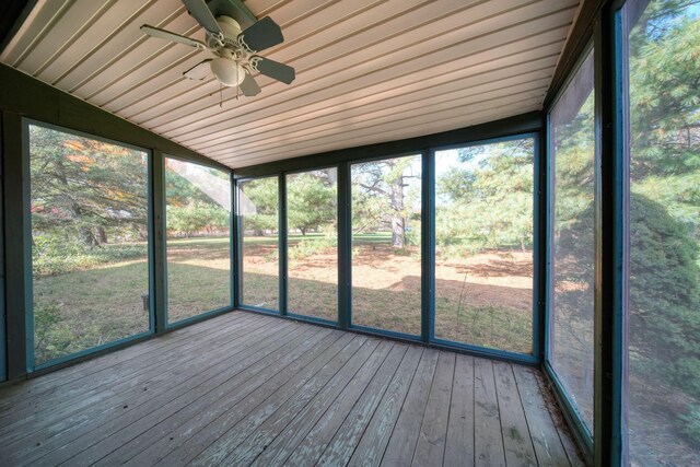 unfurnished sunroom featuring wood ceiling and ceiling fan