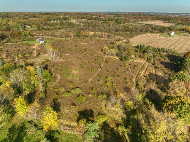 birds eye view of property with a rural view