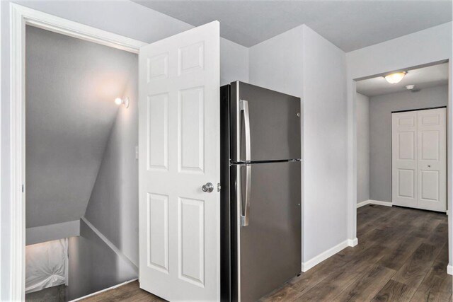 kitchen featuring dark hardwood / wood-style flooring and stainless steel refrigerator