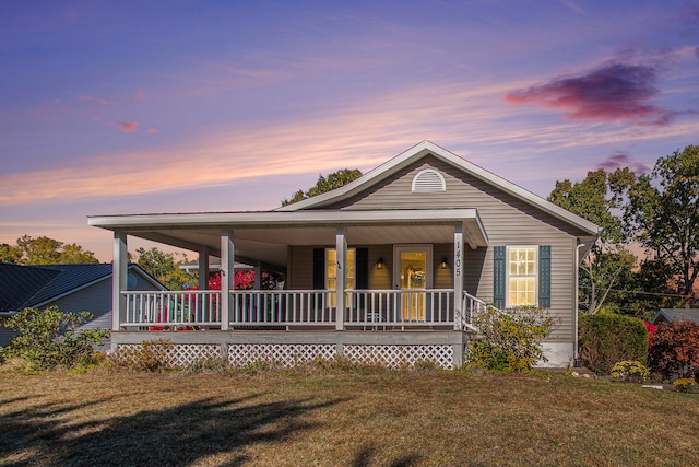 view of front facade featuring a yard and a porch