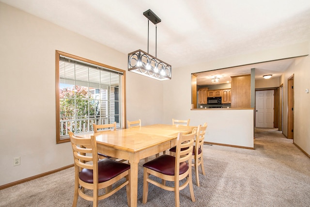 dining room with light colored carpet