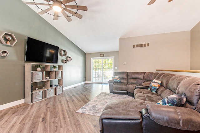 living room with hardwood / wood-style floors, high vaulted ceiling, and ceiling fan