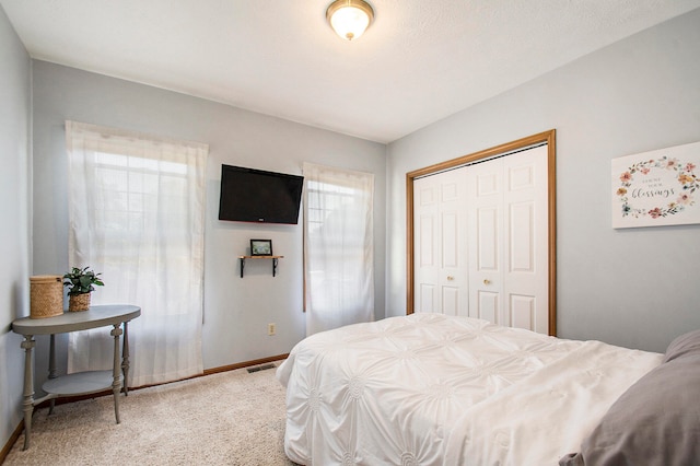 carpeted bedroom with a closet